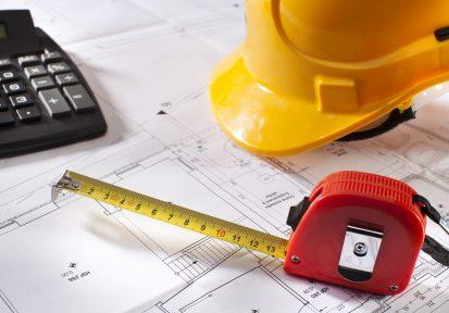 Blue prints, safety hat, measuring tape