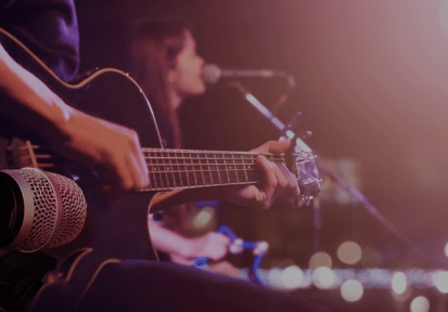 Guitarist on stage for background, soft and blur concept