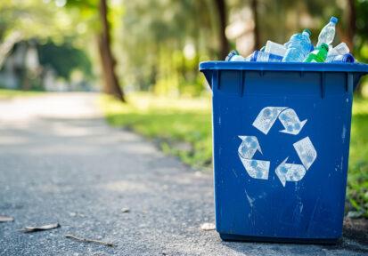 Blue recycling bin for paper waste, used to dispose of garbage a
