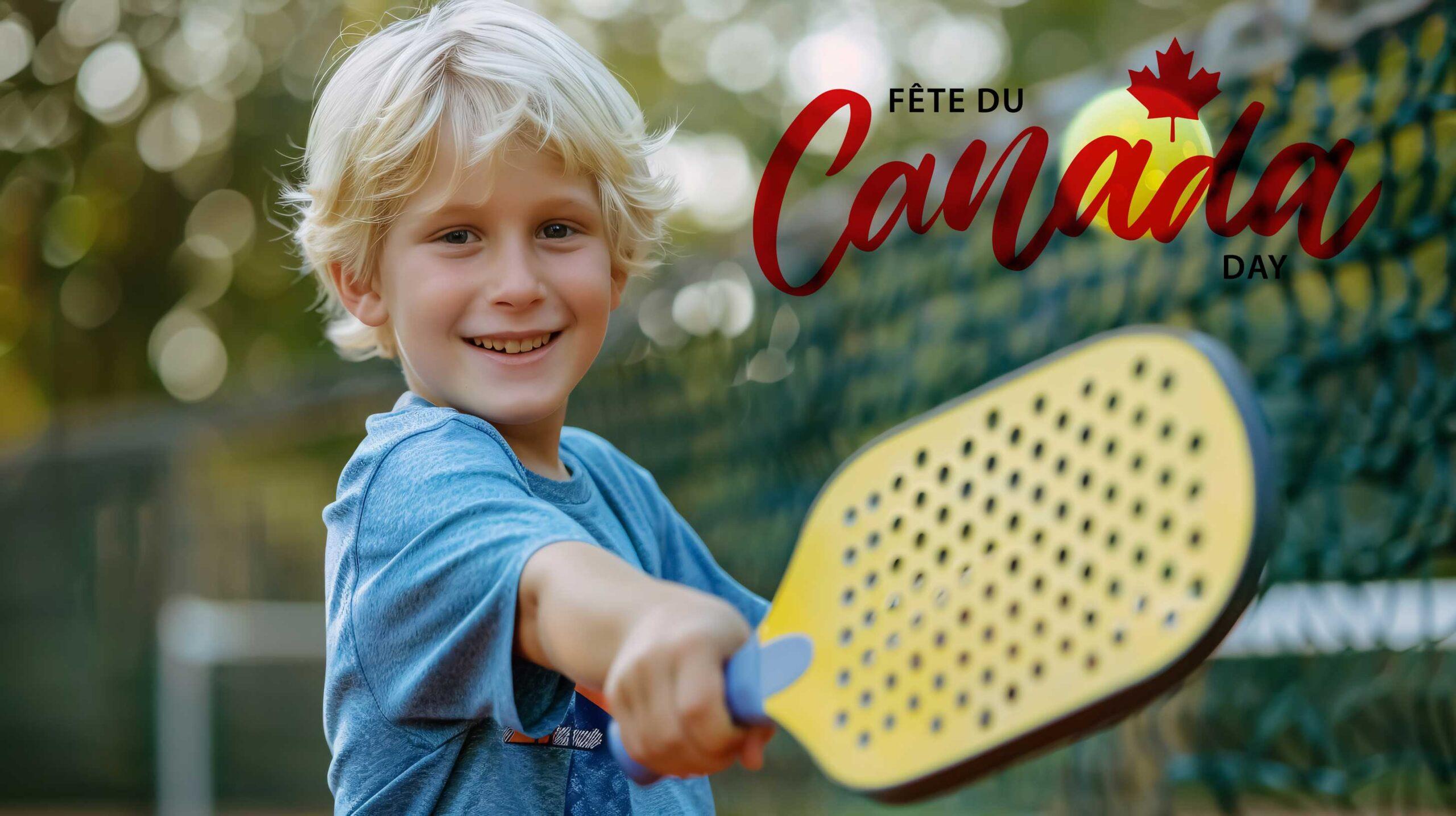 Boy smiling with pickleball racket and ball