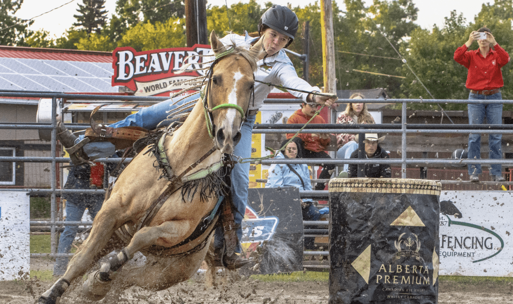 Young woman competing on horse at rodeo